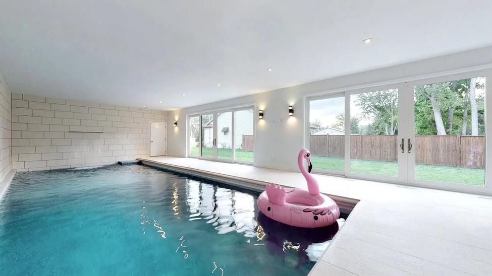 THIS EPIC $1 MLN HOME IN ONTARIO OVERLOOKS A LAKE & HAS AN INDOOR POOL WITH WATERFALL