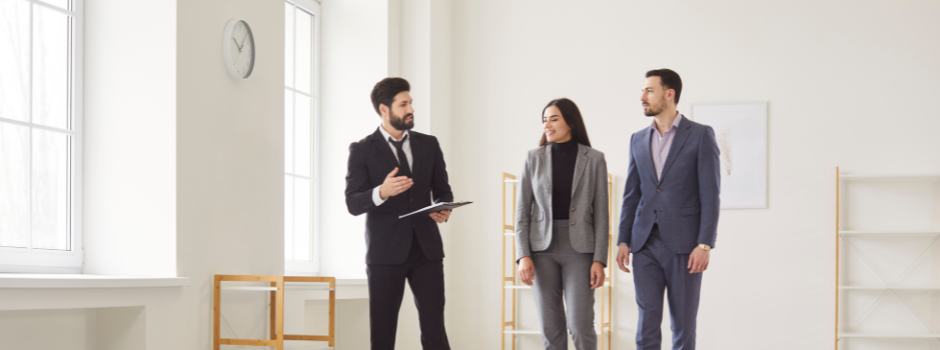 Picture of a realtor and a couple looking at a house for sale, how to get pre approved for a mortgage in Ottawa