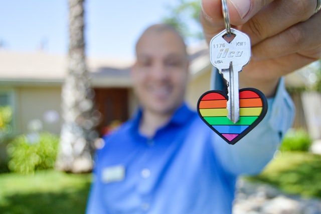 Man holding the key to a house.