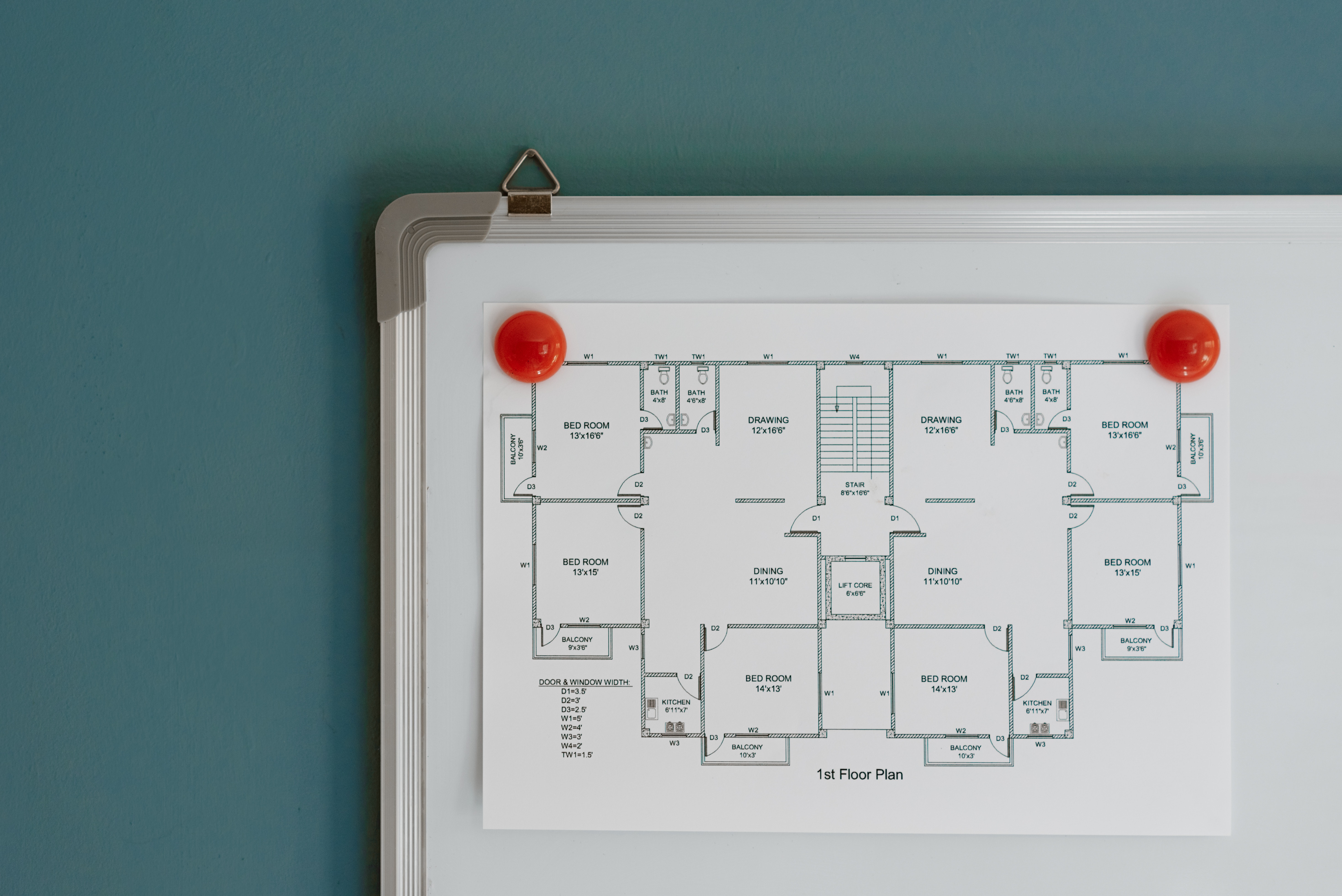 Blueprints of a home on a white magnet board