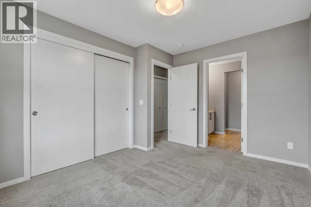 203, 140 Redstone Walk NE
